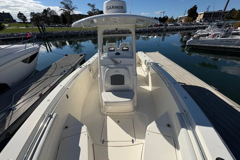 Slide: The Image of 2022 Cobia 280 Center Console boat docked at marina, featuring Garmin equipment. - 22