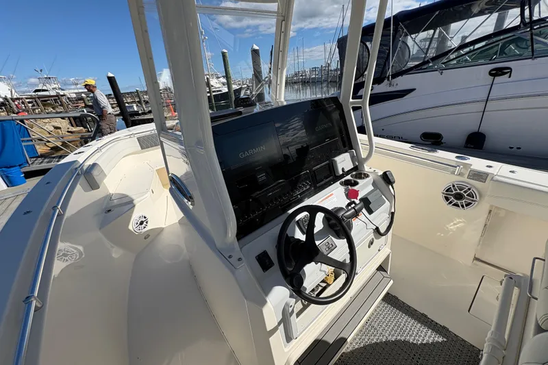 Slide: The Image of 2022 Cobia 280 Center Console boat interior with Garmin navigation system at marina. - 29