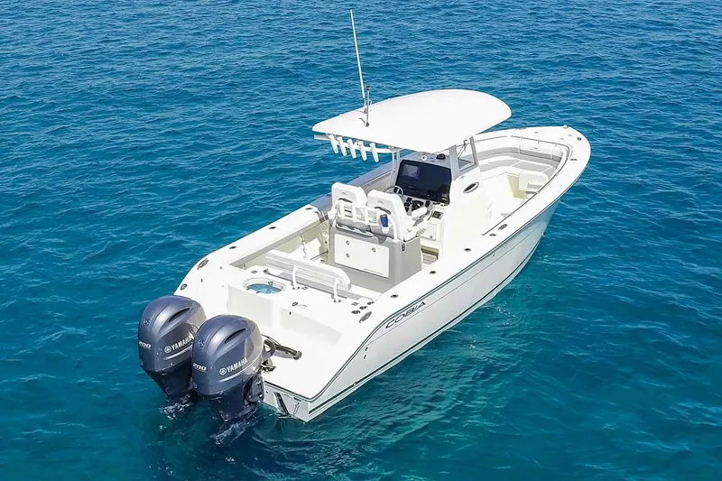 Slide: The Image of Manufacturer Provided Image: 2022 Cobia 280 Center Console boat on clear blue water. - 3