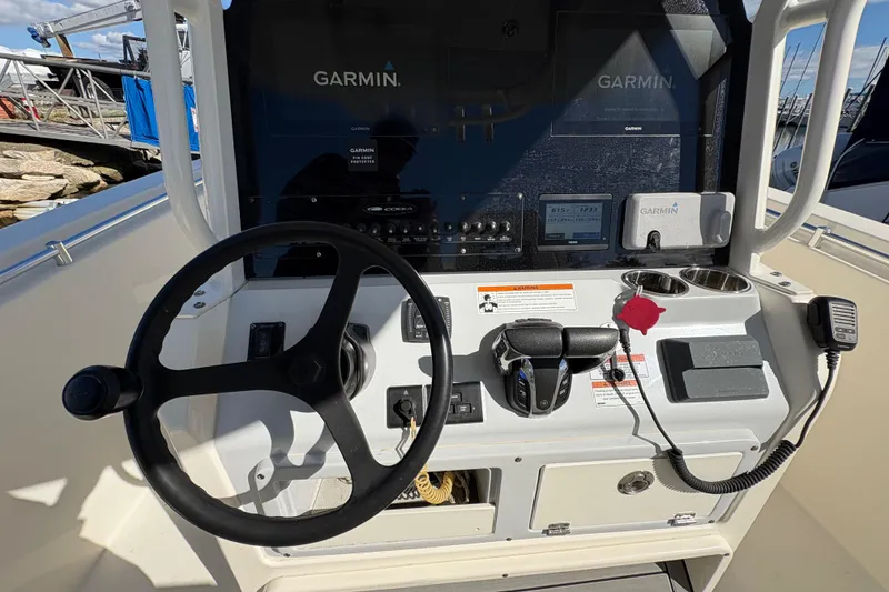 Slide: The Image of 2022 Cobia 280 Center Console helm with Garmin navigation system and steering wheel. - 32