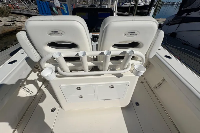 Slide: The Image of 2022 Cobia 280 Center Console boat interior with rod holders and storage compartments. - 37
