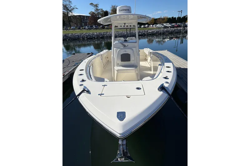 Slide: The Image of 2022 Cobia 280 Center Console boat docked on calm water. - 44