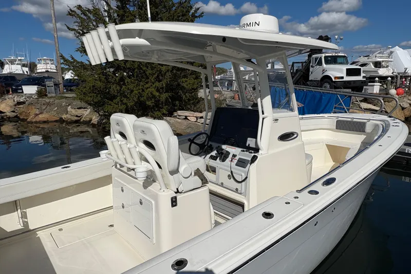 Slide: The Image of 2022 Cobia 280 Center Console boat docked, featuring dual seats and advanced navigation equipment. - 47