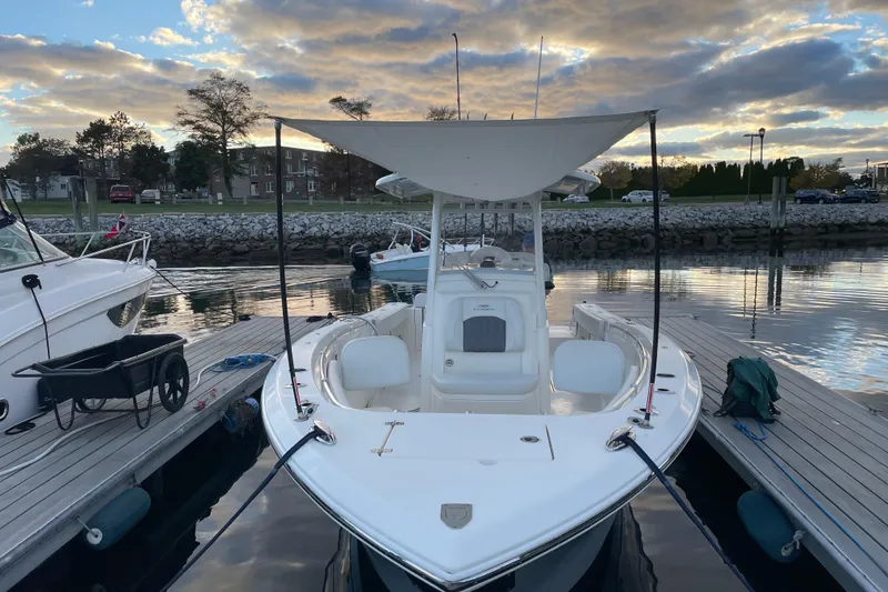Slide: The Image of 2022 Cobia 280 Center Console boat docked at marina during sunset. - 56