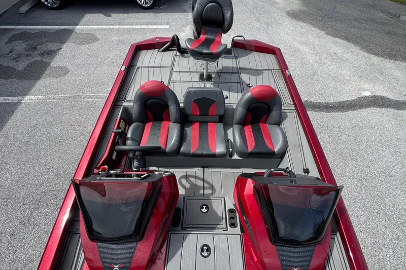 Slide: The Image of 2022 Vexus AVX1880 boat interior with red and black seating, dual consoles, and spacious layout. - 15