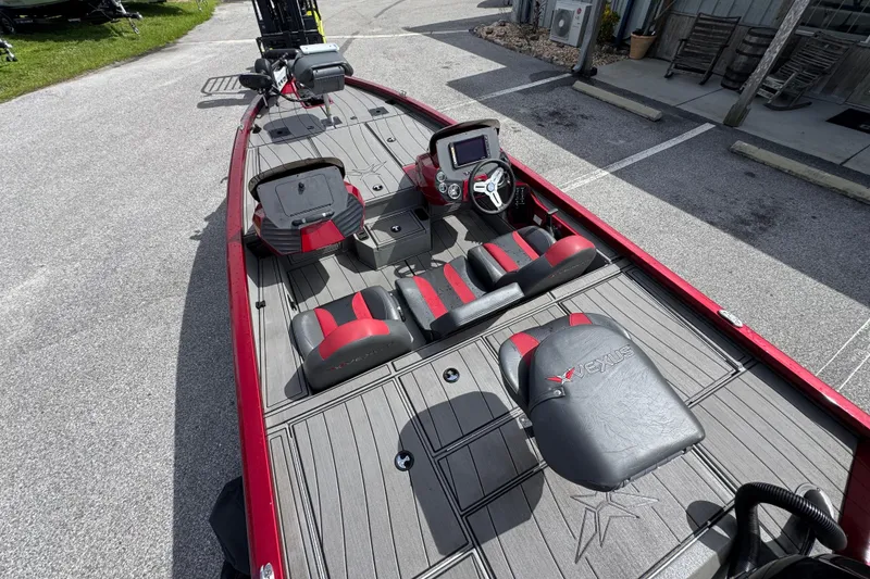 Slide: The Image of 2022 Vexus AVX1880 boat interior with red and black seating, steering console, and deck. - 17
