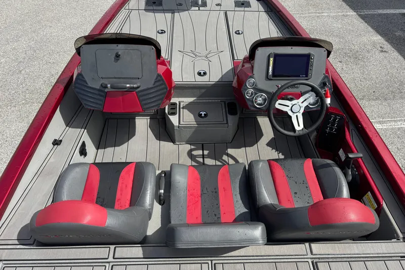 Slide: The Image of 2022 Vexus AVX1880 boat interior with red and gray seating, steering wheel, and dashboard. - 18