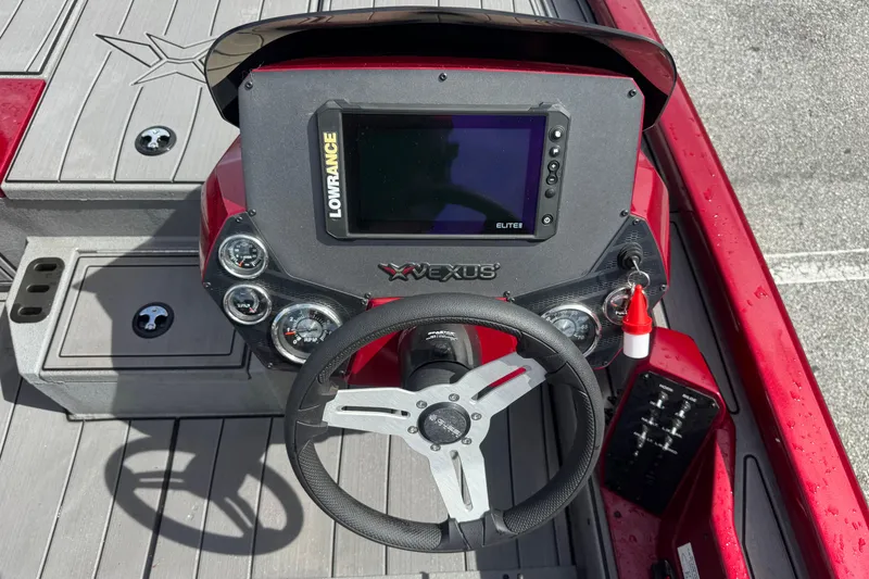 Slide: The Image of 2022 Vexus AVX1880 boat dashboard with Lowrance Elite display and steering wheel. - 19