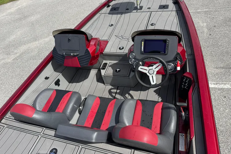 Slide: The Image of 2022 Vexus AVX1880 boat interior with red and gray seating, steering wheel, and control panel. - 20
