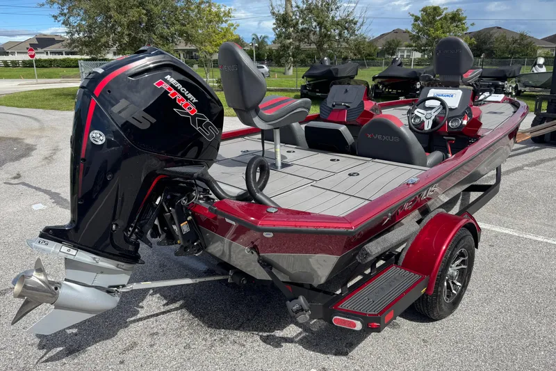 Slide: The Image of 2022 Vexus AVX1880 boat with Mercury Pro XS engine, parked outdoors. - 9