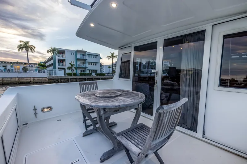 Slide: The Image of Outdoor deck of 2003 Navigator Rival 5700 yacht with table and chairs, waterfront view. - 18