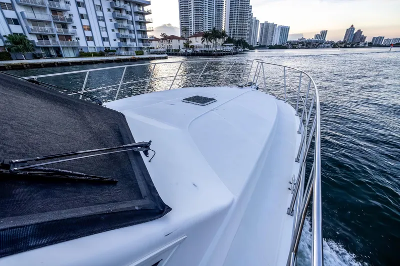 Slide: The Image of Bow view of 2003 Navigator Rival 5700 yacht cruising near waterfront buildings. - 20