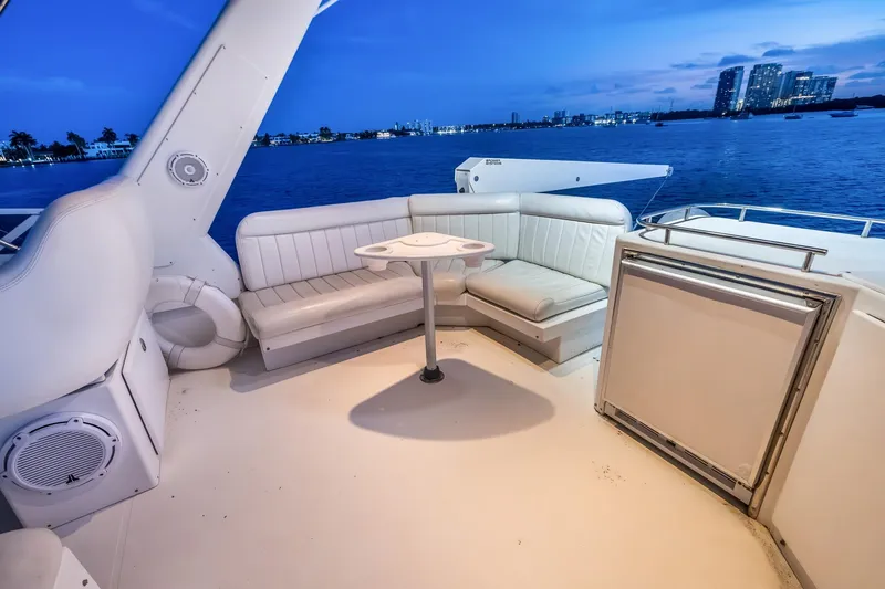 Slide: The Image of Luxurious 2003 Navigator Rival 5700 yacht deck with seating, overlooking serene waterfront. - 28