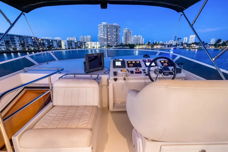 Slide: The Image of Luxurious 2003 Navigator Rival 5700 yacht interior with city skyline view at dusk. - 29