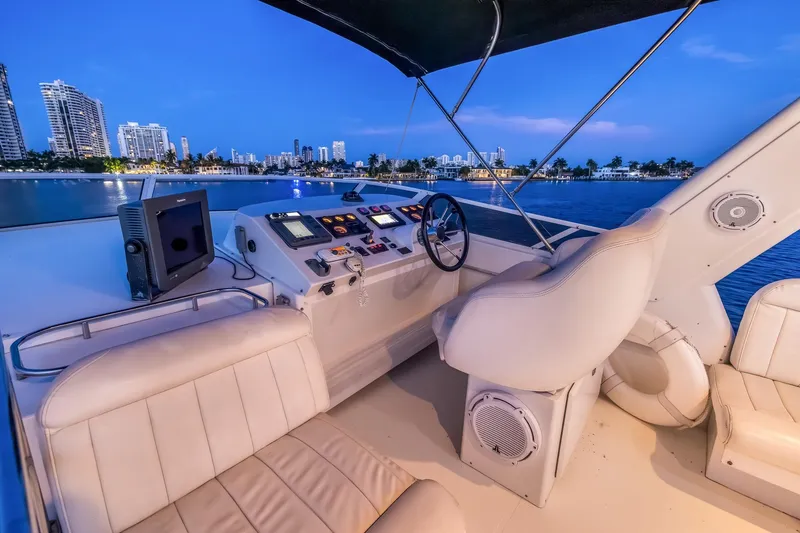 Slide: The Image of Luxurious 2003 Navigator Rival 5700 yacht interior with city skyline view at dusk. - 30