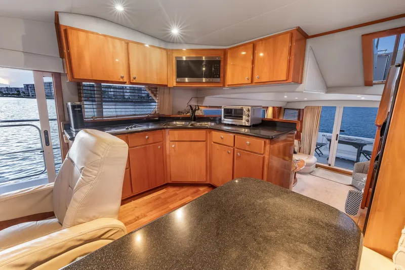 Slide: The Image of Luxurious 2003 Navigator Rival 5700 yacht interior with modern kitchen and waterfront view. - 34