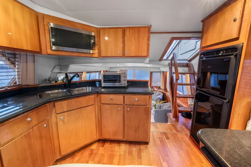 Slide: The Image of Luxurious kitchen interior of 2003 Navigator Rival 5700 yacht with wooden cabinetry. - 36