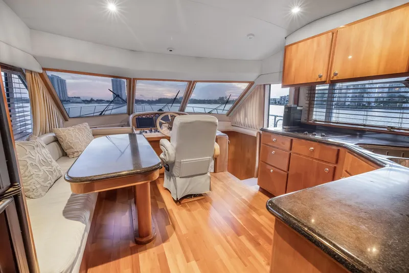 Slide: The Image of Luxurious interior of 2003 Navigator Rival 5700 yacht with elegant wood finishes and panoramic windows. - 37