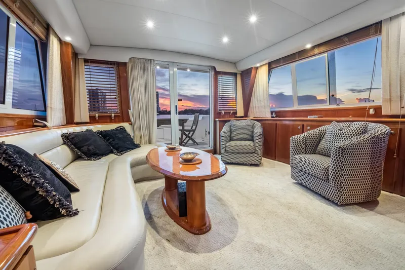 Slide: The Image of Luxurious interior of 2003 Navigator Rival 5700 yacht with elegant seating and sunset view. - 38