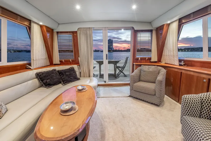 Slide: The Image of Luxurious 2003 Navigator Rival 5700 yacht interior with elegant seating and stunning sunset view. - 42