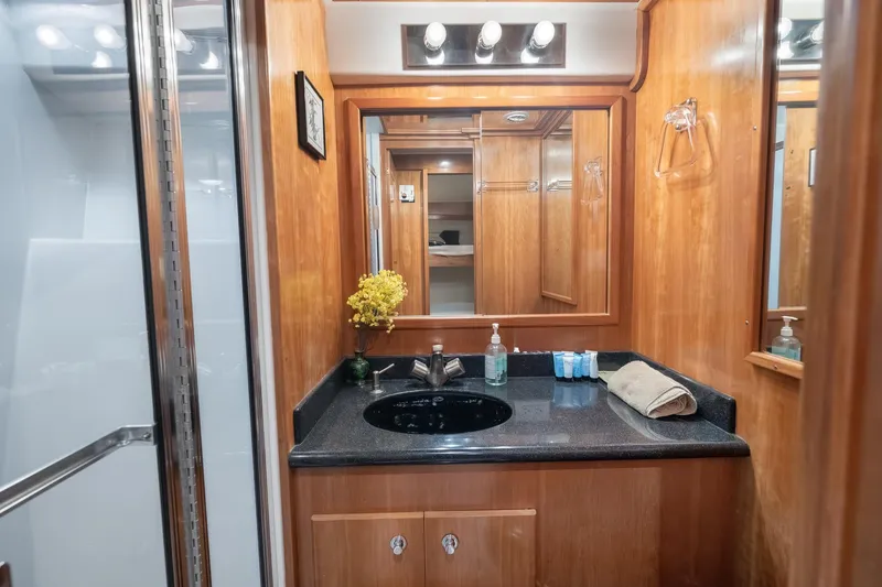 Slide: The Image of Luxurious wooden bathroom interior in 2003 Navigator Rival 5700 yacht, featuring elegant fixtures. - 46