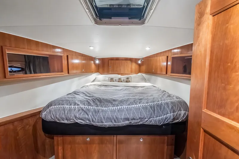 Slide: The Image of Luxurious bedroom interior of 2003 Navigator Rival 5700 yacht with wood paneling and skylight. - 47