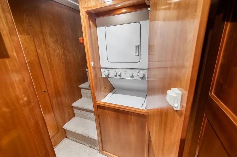 Slide: The Image of Laundry area with stacked washer-dryer in 2003 Navigator Rival 5700 yacht. - 49