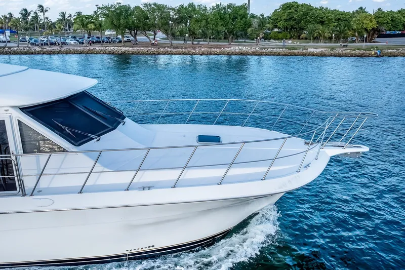 Slide: The Image of 2003 Navigator Rival 5700 yacht cruising on a serene blue waterway. - 7