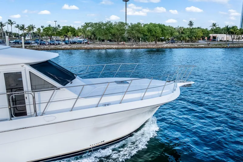 Slide: The Image of 2003 Navigator Rival 5700 yacht cruising on a scenic waterway. - 8