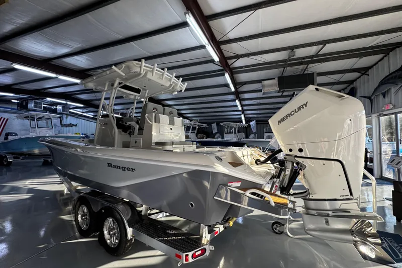 Slide: The Image of 2026 Ranger 2600 Bay boat with Mercury engine in showroom. - 10
