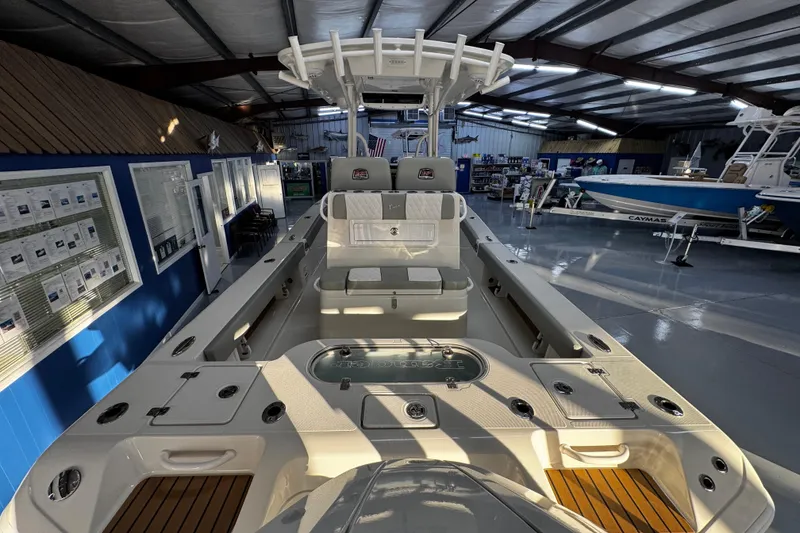 Slide: The Image of 2026 Ranger 2600 Bay boat interior in showroom, featuring seating and storage compartments. - 12