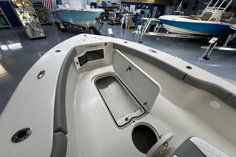 Slide: The Image of 2026 Ranger 2600 Bay boat interior with storage compartments in a showroom. - 14