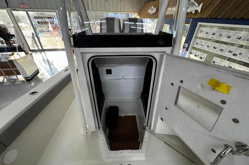 Slide: The Image of 2026 Ranger 2600 Bay boat interior cabin view in showroom setting. - 15