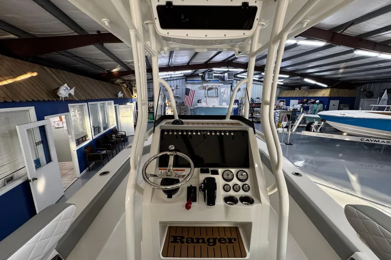 Slide: The Image of 2026 Ranger 2600 Bay boat interior with steering console in showroom. - 17