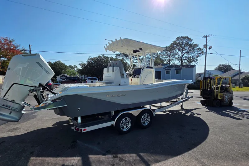 Slide: The Image of 2026 Ranger 2600 Bay boat on trailer with Mercury engine in sunny outdoor setting. - 3