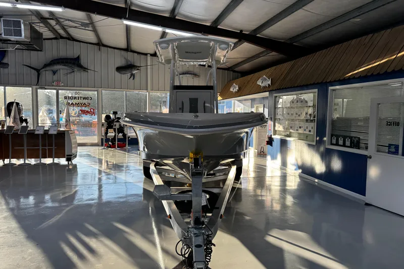 Slide: The Image of 2026 Ranger 2600 Bay boat displayed in a showroom with marine decor. - 5