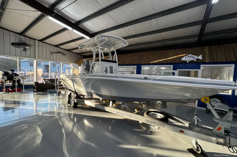 Slide: The Image of 2026 Ranger 2600 Bay boat displayed indoors on a trailer. - 6