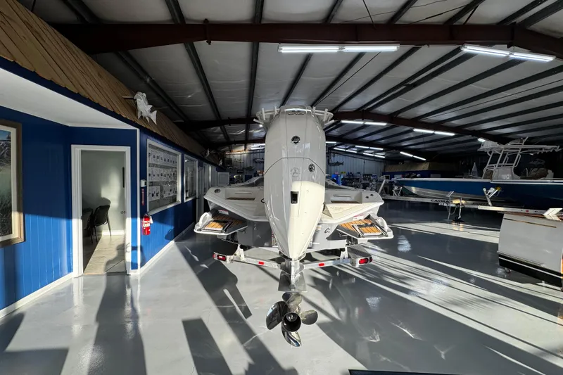 Slide: The Image of 2026 Ranger 2600 Bay boat displayed in a showroom with blue walls and bright lighting. - 9