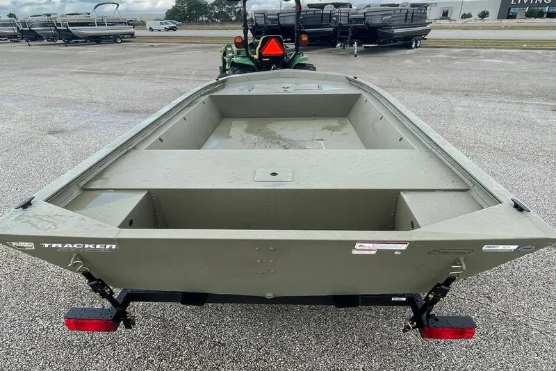 Slide: The Image of 2026 Tracker Grizzly 1648 Utility boat on trailer, parked outdoors. - 2