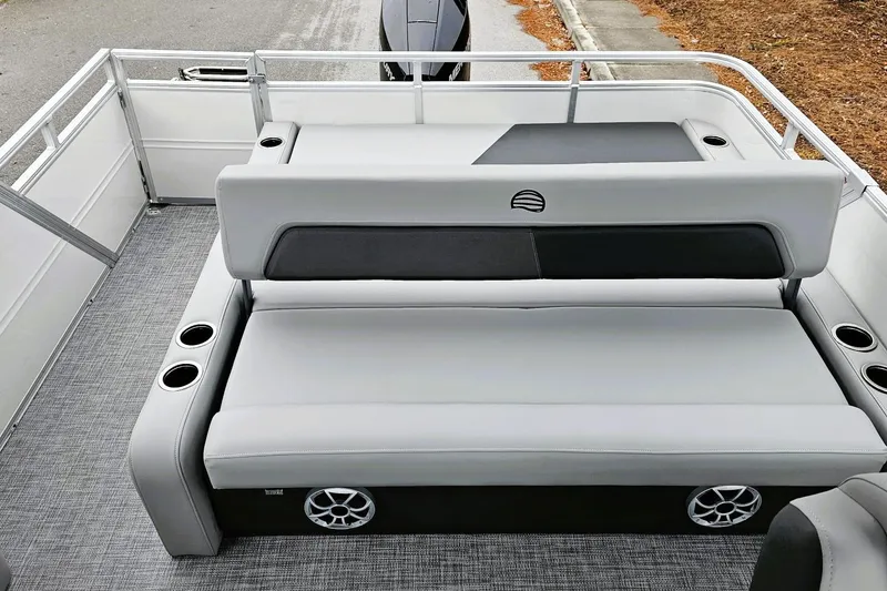 Slide: The Image of 2026 Sun Tracker Party Barge 22 RF XP3 interior with gray seating and steering console. - 12