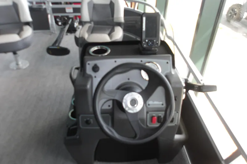Slide: The Image of 2026 Sun Tracker Bass Buggy 16 XL Select boat console with steering wheel and controls. - 17