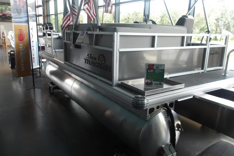 The Image of 2026 Sun Tracker Bass Buggy 16 XL Select pontoon boat displayed indoors. - 2