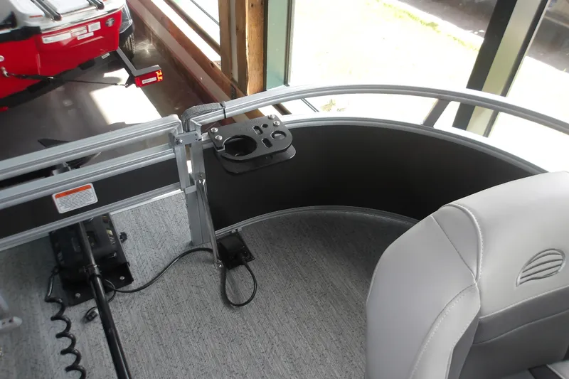 Slide: The Image of Interior of 2026 Sun Tracker Bass Buggy 16 XL Select pontoon boat with seating and control panel. - 16