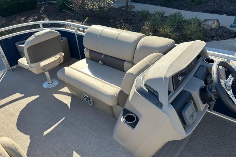 Slide: The Image of 2025 Sun Tracker Fishin' Barge 20 DLX interior with seating and steering console. - 4