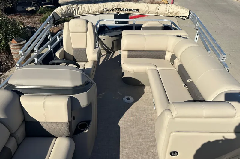 Slide: The Image of 2025 Sun Tracker Fishin' Barge 20 DLX with beige seating and spacious deck layout. - 7