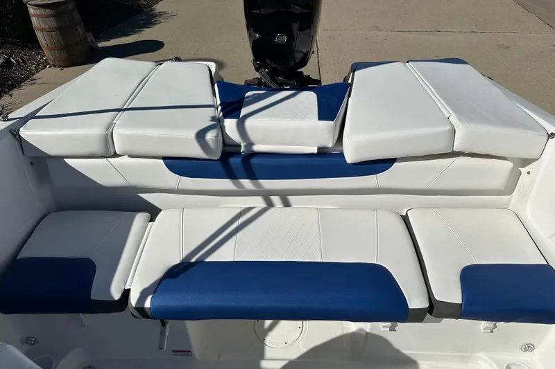 Slide: The Image of 2024 Tahoe 185 S boat interior with blue and white cushioned seating. - 10