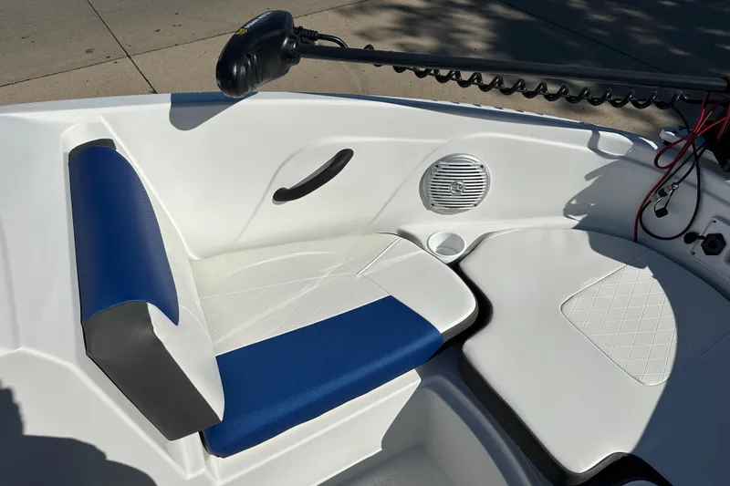 Slide: The Image of 2024 Tahoe 185 S boat interior with blue and white seating, speaker, and cup holder. - 4