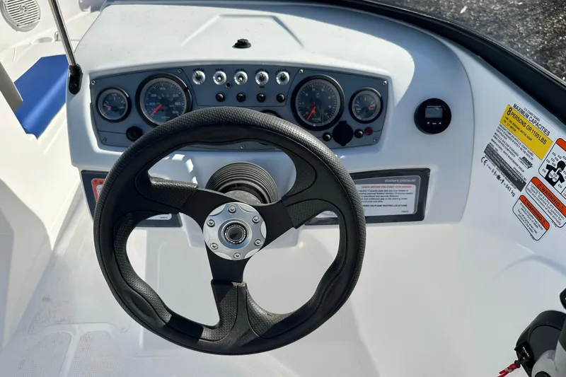 Slide: The Image of Steering wheel and dashboard of 2024 Tahoe 185 S boat, featuring gauges and controls. - 7