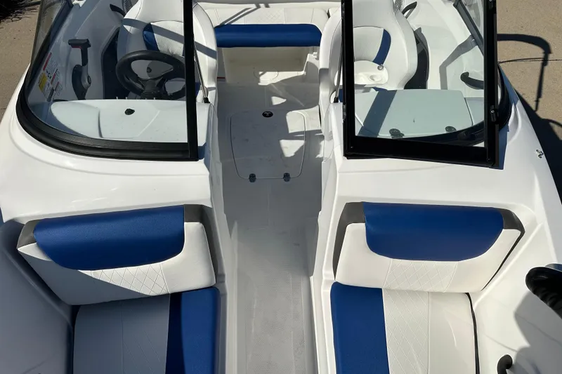 Slide: The Image of 2024 Tahoe 185 S boat interior with blue and white seating, open windshield. - 8