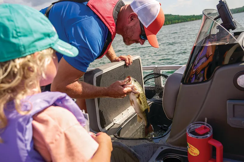 Slide: The Image of 2026 Sun Tracker Bass Buggy 18 DLX boat helm with cushioned seat and steering wheel. - 10